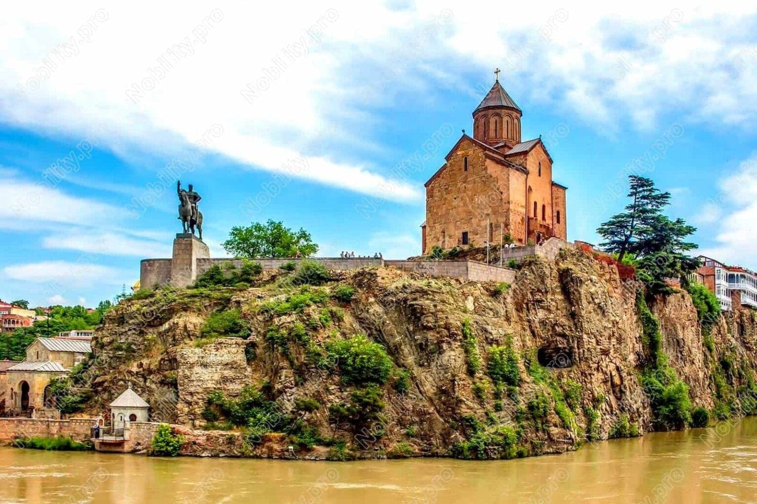 Historic Metekhi Church overlooking Tbilisi skyline and Kura River